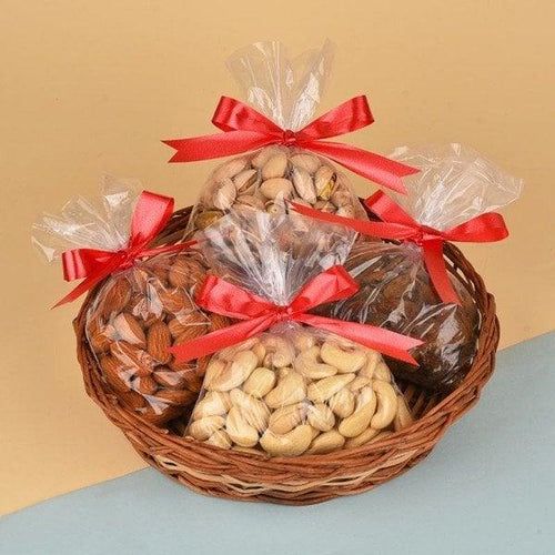 Gift basket with assorted dry fruits in clear bags tied with red ribbons
