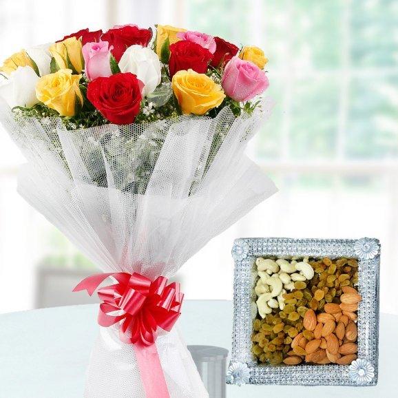 Bouquet of colorful flowers with a decorative box of assorted nuts 