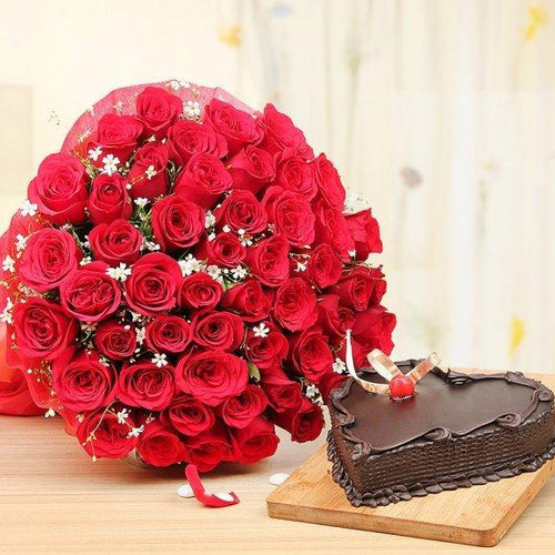 Bouquet of red roses and a chocolate cake 