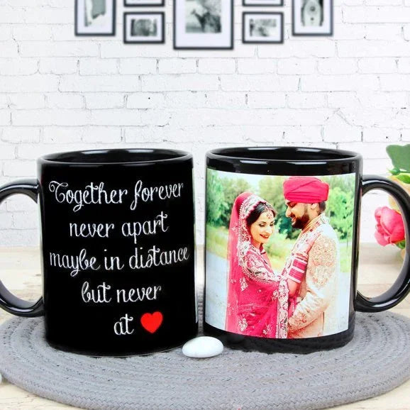Two black mugs with personalized designs on a white brick wall background.
