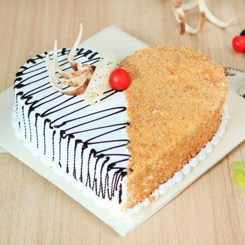 Partial view of a cake with a slice cut out on a wooden surface