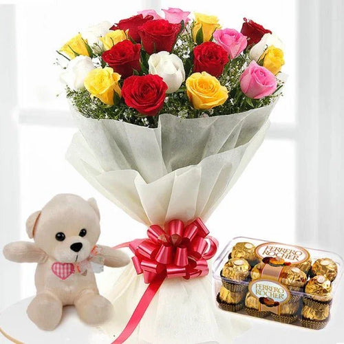 Bouquet of colorful roses with a teddy bear and chocolate box on a white background