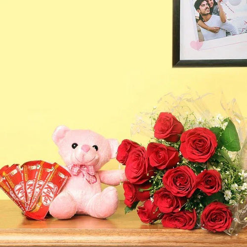Pink teddy bear with red roses Kit Kat on a wooden surface against a yellow wall.