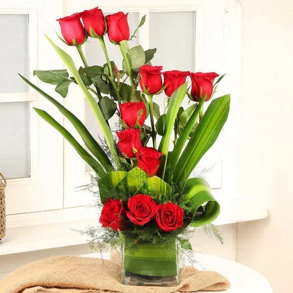 12 Red Roses in Square Glass Vase Arrangement - Flower Delivery in GiftsGhaziabad