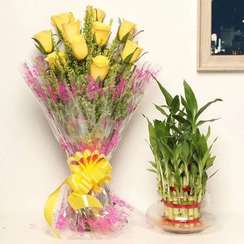 Bouquet of yellow roses and pink flowers with a green potted plant on a white background