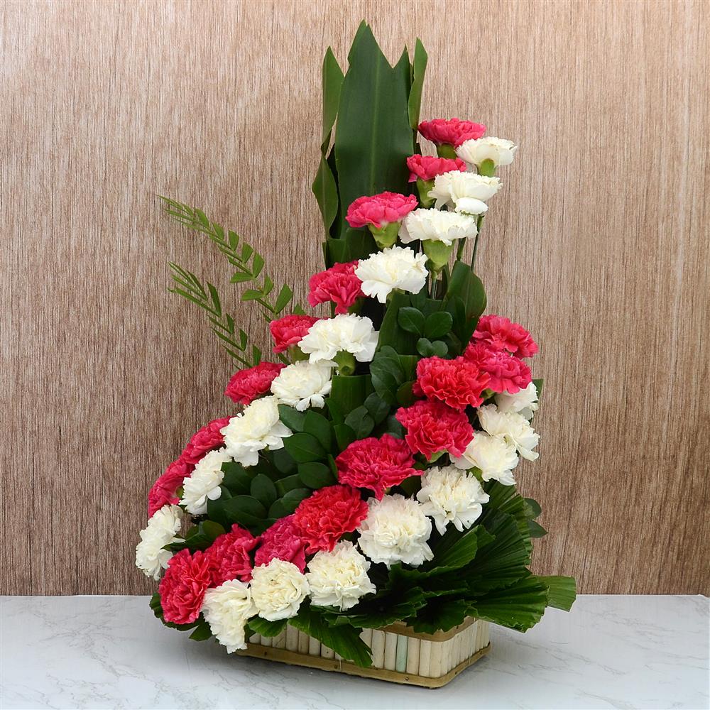 Red And White Carnations In A Cane Basket